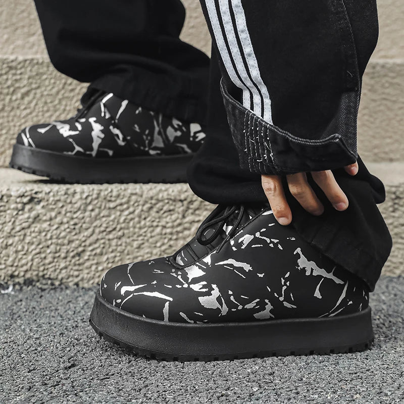 Men’s VOIDWEAR VDR_VANISH_02 shadow winter boots with platform sole, microfiber leather, and ritual-inspired design, styled for urban streetwearBlack and white camouflage shoes worn with black pants featuring white stripes.