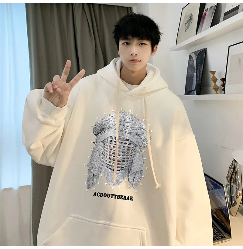 VOIDWEAR VDR_SHDW_07 oversized goth hoodie with masked figure graphic, in black, styled in urban streetwear fit. Person wearing a white hoodie with a graphic design and text, making a peace sign.