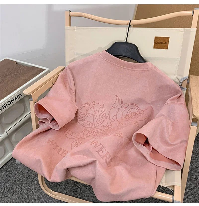 VOIDWEAR VDR_FLO_09 oversized goth floral graphic t-shirt in apricot, styled for streetwear layering. Pink sweatshirt with floral design on a chair