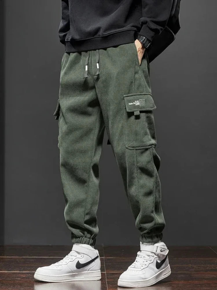 Voidwear VX13 Flux cargo pants in matte black styled with urban techwear layering on night streets
