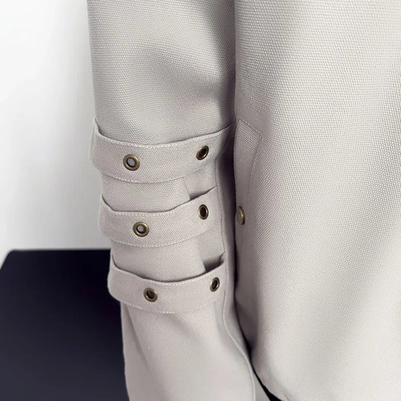 VOIDWEAR VDR_VANISH_05 ☰ black khaki jacket — ritual-inspired streetwear with signal glyph embroidery, minimalist techwear layering. Close-up of a light gray jacket with button details on a white background
