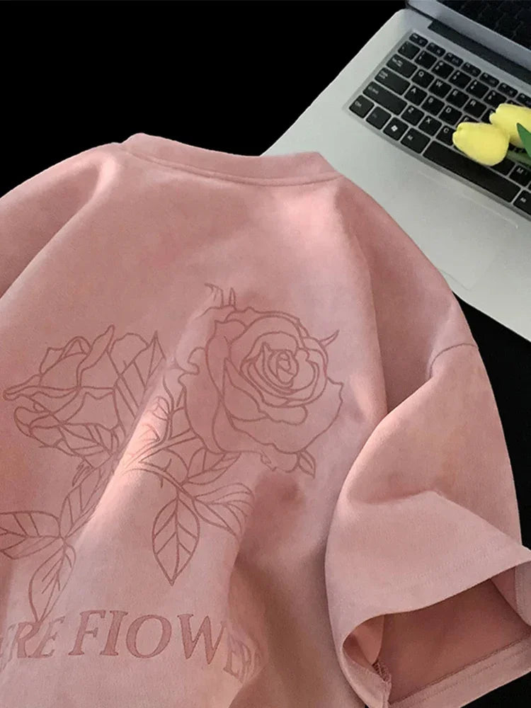 VOIDWEAR VDR_FLO_09 oversized goth floral graphic t-shirt in apricot, styled for streetwear layering. Pink sweatshirt with floral design and text next to a laptop.