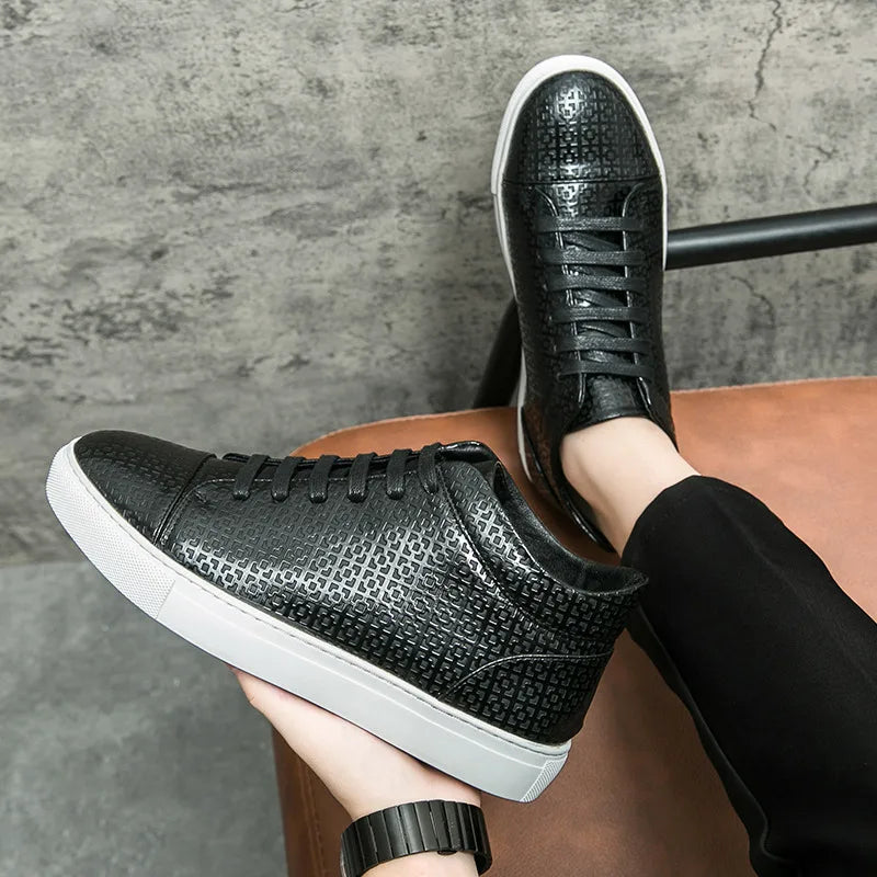 Black textured sneakers with white soles worn by a person sitting on a brown chair against a gray concrete wall.