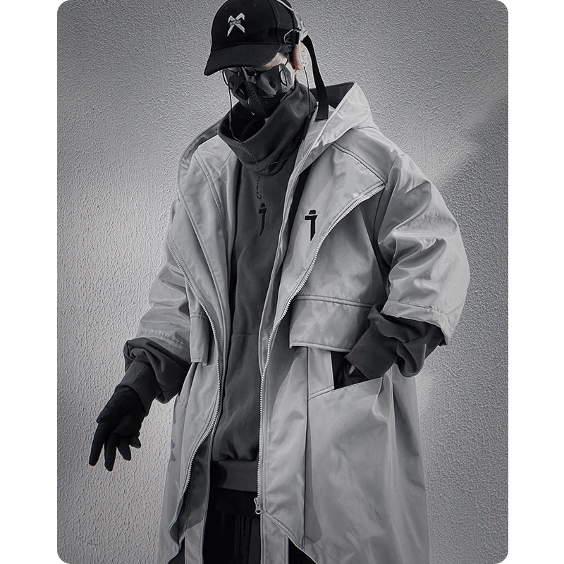 A male model in the Voidwear SIGNAL_VANISH_05 ☰, a minimalist and conceptual mid-sleeved hooded trench coat designed for stylish urban wear in the US and EU.