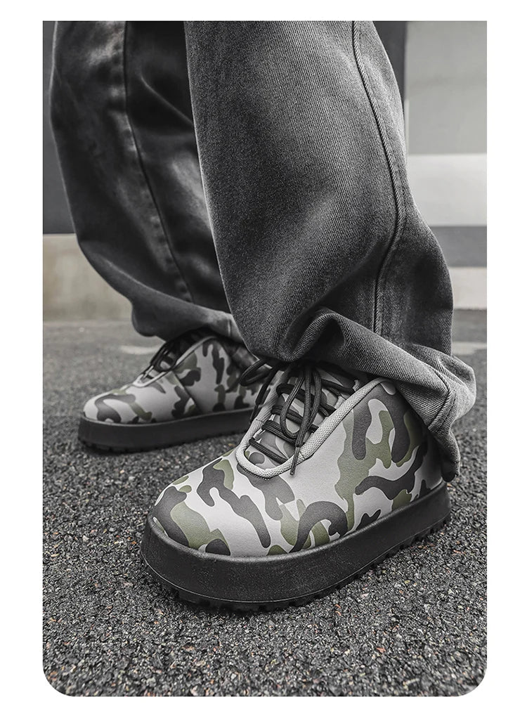 Camouflage-patterned shoes worn with dark pants on a gray pavement. VOIDWEAR CODE_SYSTEM_07 ⚔️ chunky sneaker-style boots shown on a city street in winter, highlighting the microfiber leather upper and thick platform sole.
