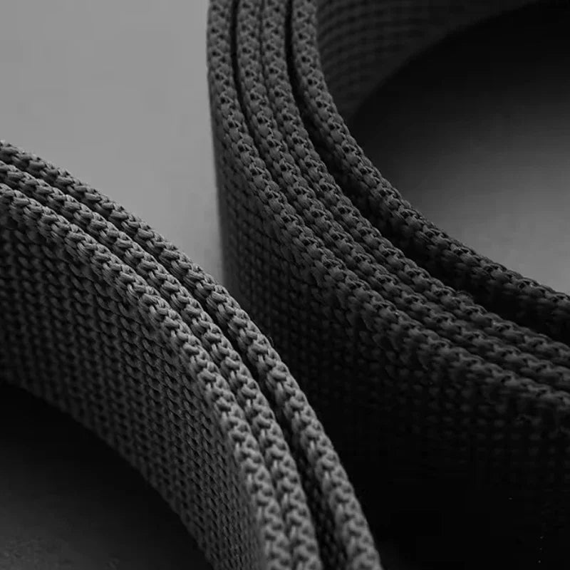 Close-up of textured black and gray fabric loops on a dark background