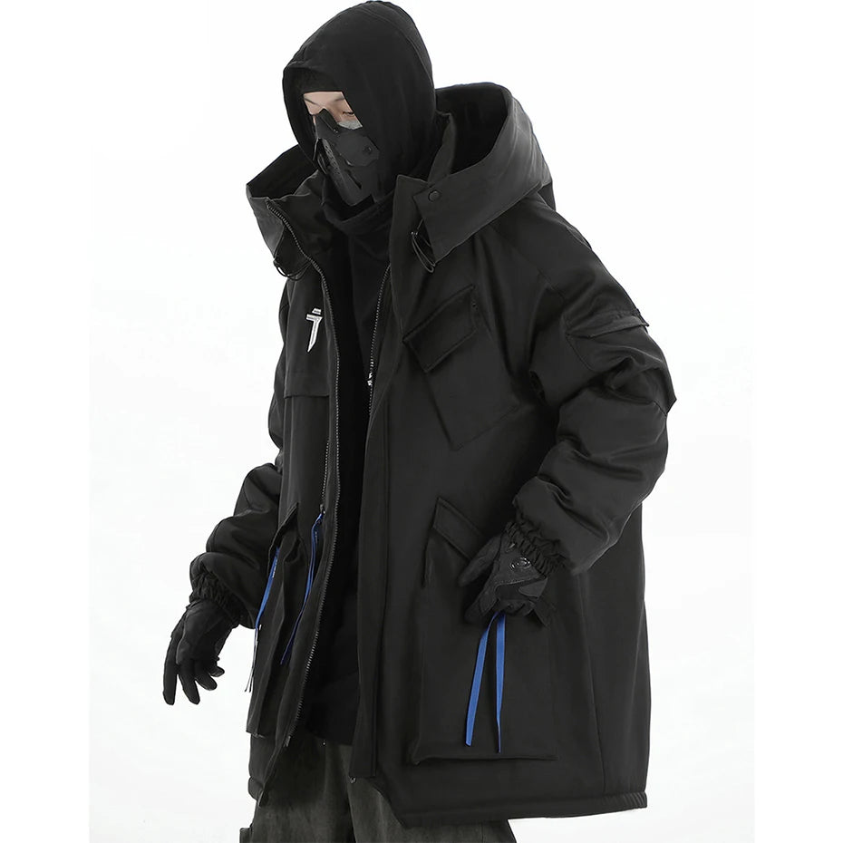 Person wearing a black hooded jacket with blue zippers on a white background