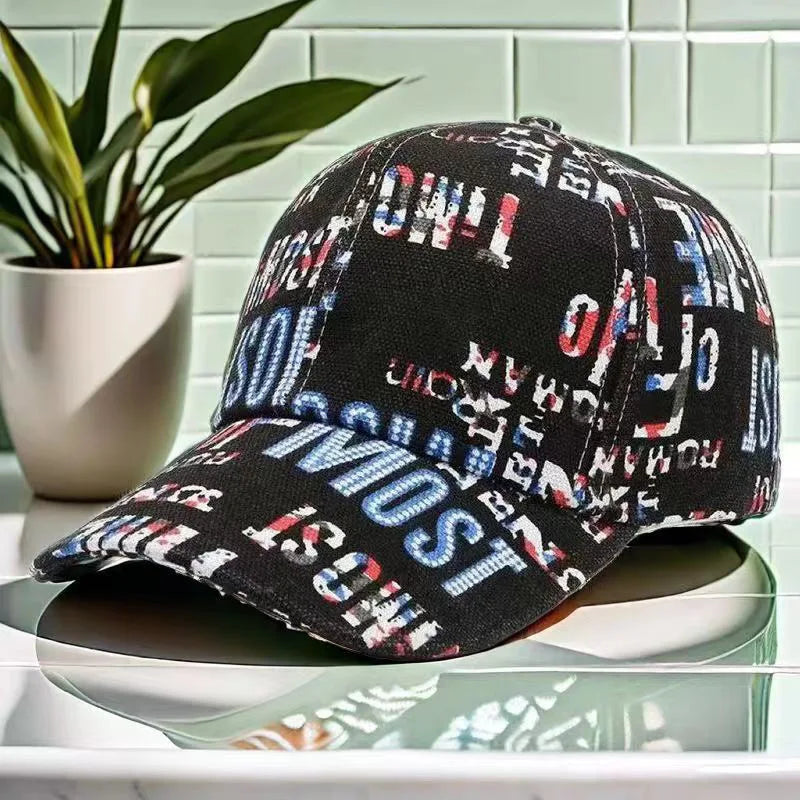 VOIDWEAR Ritual-Inspired Streetwear. Black cap with colorful text pattern on a reflective surface with a plant in the background