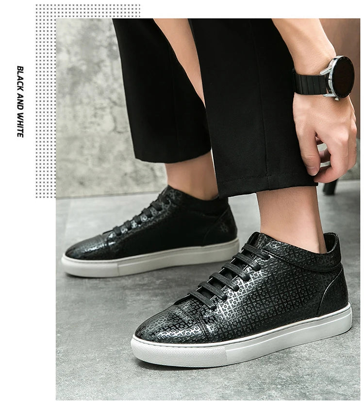 Black and white sneakers worn by a person on a gray pavement. VOIDWEAR SYSTEM_MOTION_07 ⏚ high-top sneakers, crafted from breathable PU leather with a subtle print, shown on a man in a modern streetwear outfit.