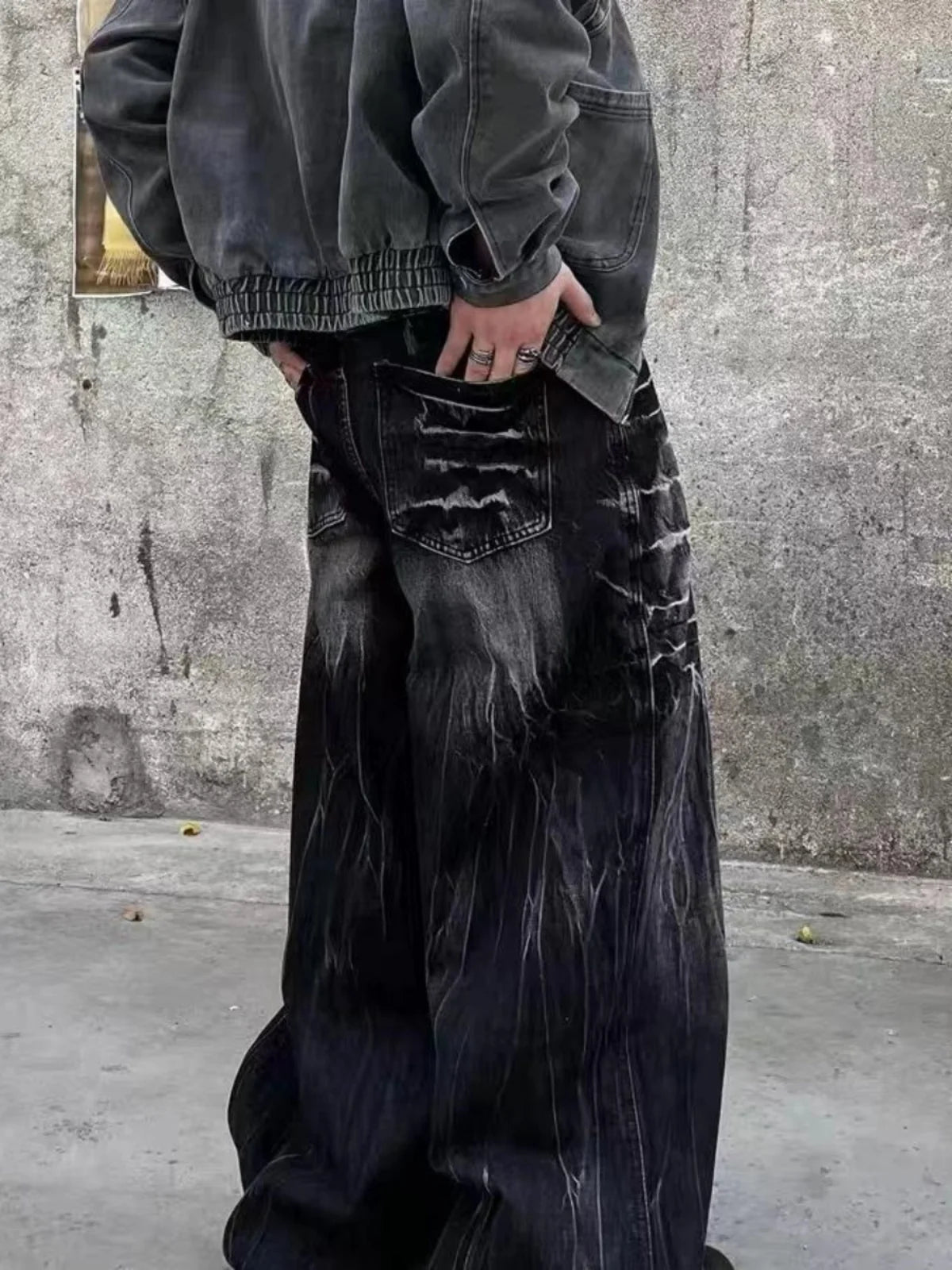 VOIDWEAR SIGNAL_STORM_11 ☰ black lightning jeans shown in Los Angeles alleyway — washed denim texture and storm pattern visible under sunlight.