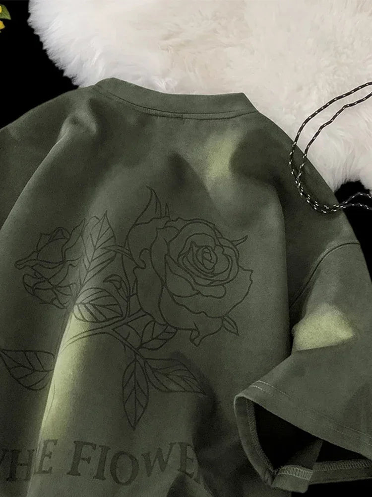 VOIDWEAR VDR_FLO_09 oversized goth floral graphic t-shirt in apricot, styled for streetwear layering. Green sweatshirt with a rose design and text on a white surface