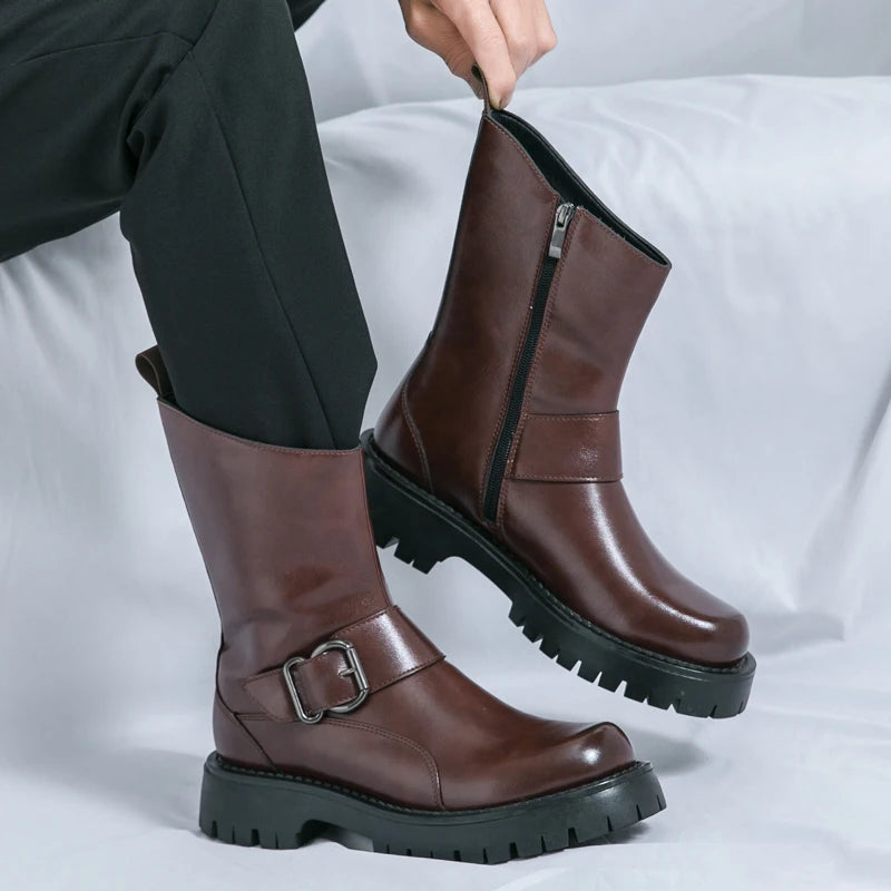 Brown leather boots with a buckle on a white background