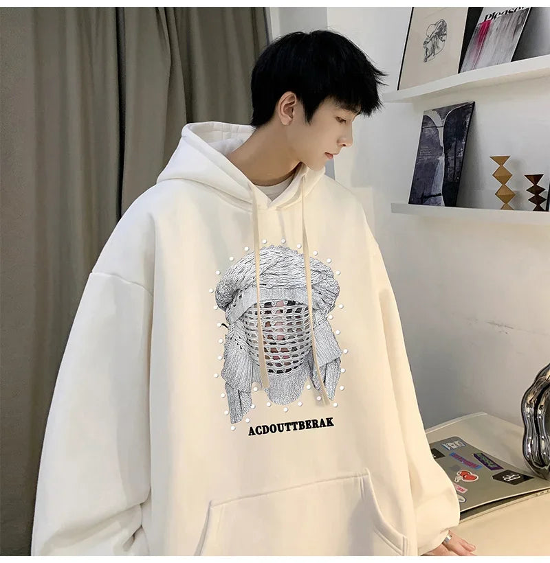 VOIDWEAR VDR_SHDW_07 oversized goth hoodie with masked figure graphic, in black, styled in urban streetwear fit. Person wearing a white hoodie with a graphic design and text in an indoor setting.