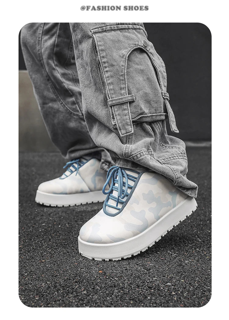 White sneakers with blue accents worn with gray cargo pants on a dark surface. VOIDWEAR CODE_SYSTEM_07 ⚔️ chunky sneaker-style boots shown on a city street in winter, highlighting the microfiber leather upper and thick platform sole.