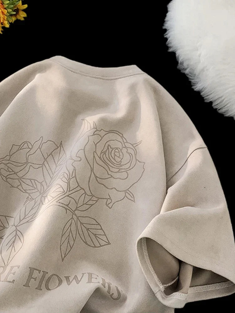 VOIDWEAR VDR_FLO_09 oversized goth floral graphic t-shirt in apricot, styled for streetwear layering. Beige sweatshirt with floral design and text on a dark background