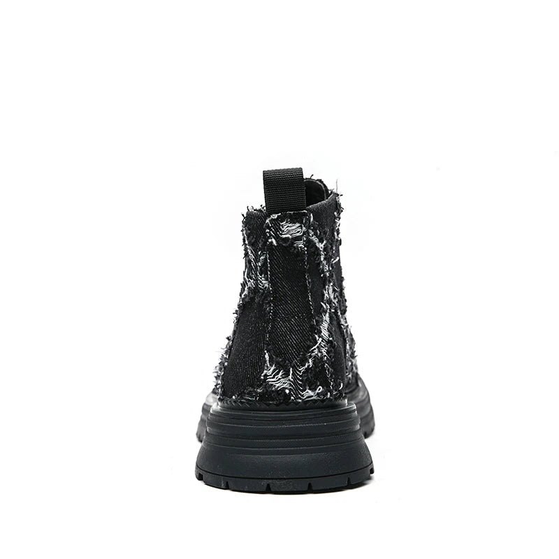 Black boot with textured sole on a white background. VOIDWEAR SIGNAL_VANISH_07 ☰ high-top split leather loafers with slip-on design, breathable build, and shadow-motion streetwear aesthetic