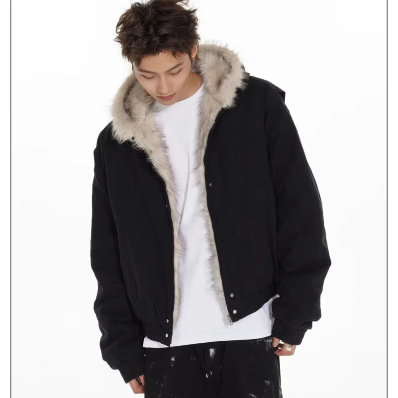 VOIDWEAR™ VDR_25 — a unisex oversized plush hooded jacket. Person wearing a black jacket with fur hood on a white background