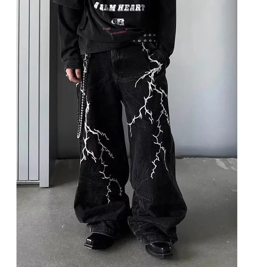 VOIDWEAR SIGNAL_STORM_07 ⚡ embroidered lightning jeans worn on Brooklyn rooftop at dusk, vintage wash visible on loose straight cut