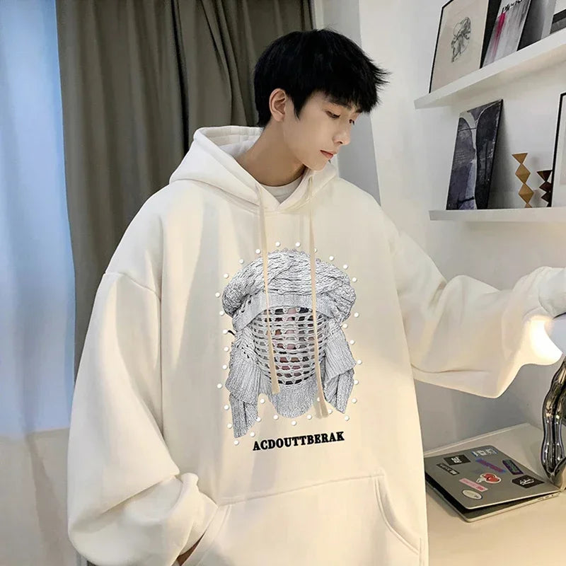 VOIDWEAR VDR_SHDW_07 oversized goth hoodie with masked figure graphic, in black, styled in urban streetwear fit. Person wearing a white hoodie with a graphic design in a room.