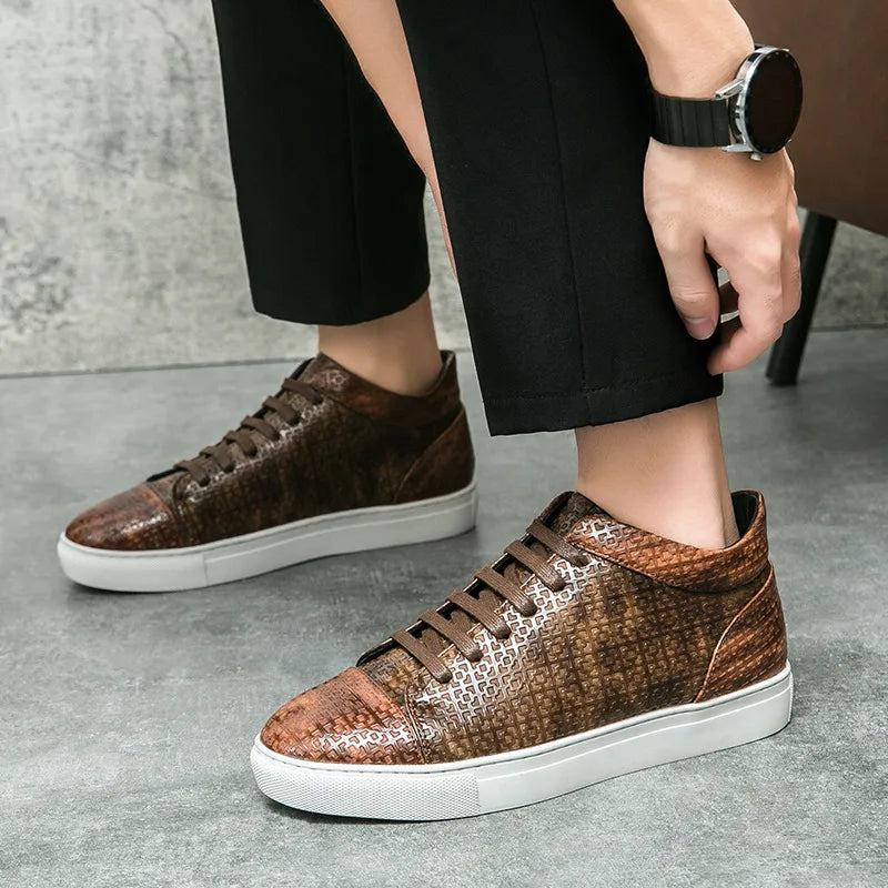 Brown patterned sneakers worn with black pants on a gray floor. VOIDWEAR SYSTEM_MOTION_07 ⏚ high-top sneakers, crafted from breathable PU leather with a subtle print, shown on a man in a modern streetwear outfit.