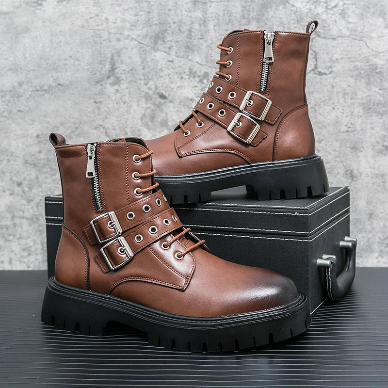 Brown leather boots with buckles on a black box against a gray textured background