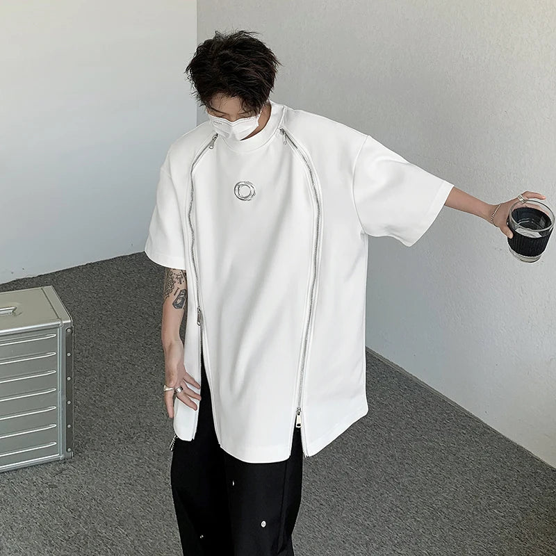 VOIDWEAR SIGNAL_07 padded shoulder oversized tee, double zipper streetwear, ritual-coded glyph sleeve. Person wearing a white zip-up hoodie and black pants in an indoor setting.