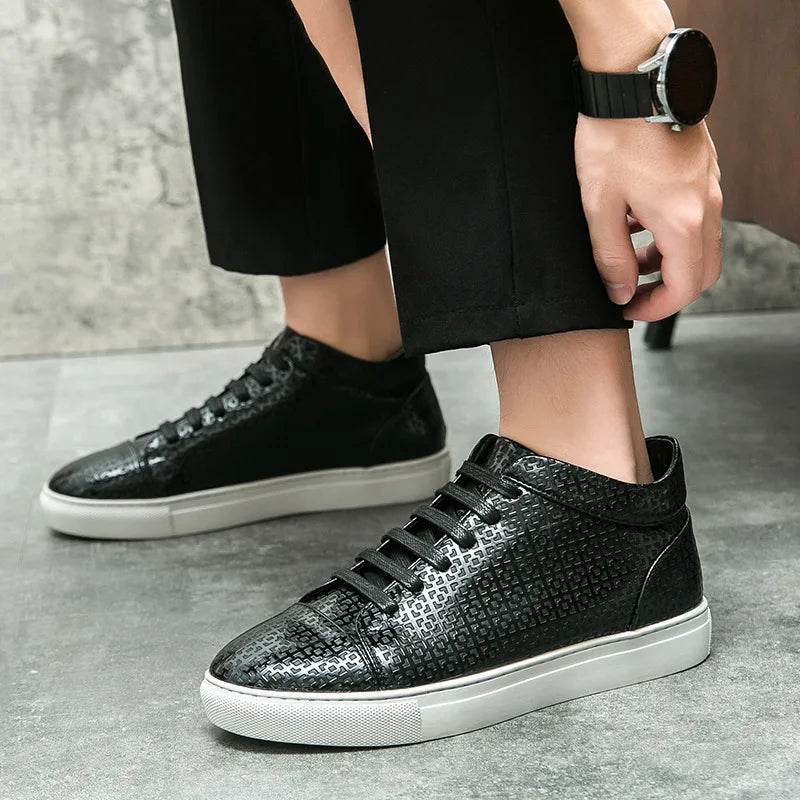 Black sneakers with white soles worn by a person on a gray surface. VOIDWEAR SYSTEM_MOTION_07 ⏚ high-top sneakers, crafted from breathable PU leather with a subtle print, shown on a man in a modern streetwear outfit.