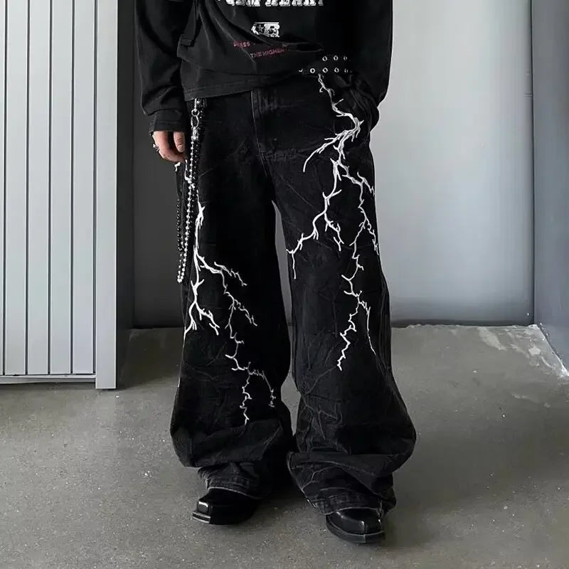 VOIDWEAR SIGNAL_STORM_07 ⚡ embroidered lightning jeans worn on Brooklyn rooftop at dusk, vintage wash visible on loose straight cut