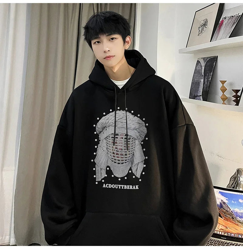 VOIDWEAR VDR_SHDW_07 oversized goth hoodie with masked figure graphic, in black, styled in urban streetwear fit. Person wearing a black hoodie with a graphic design in a room.