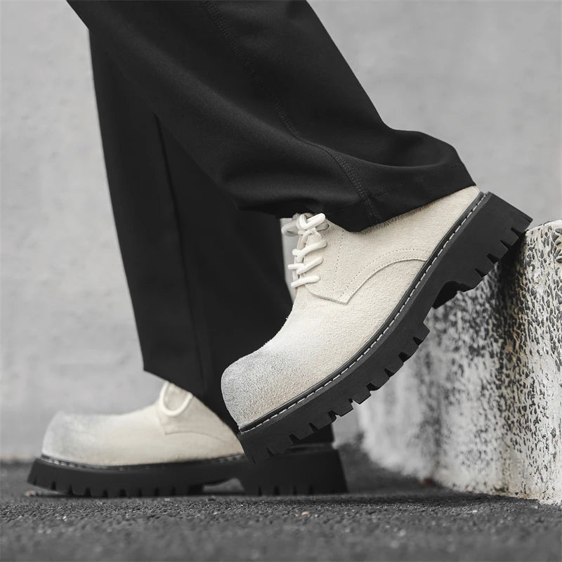 Men’s VOIDWEAR VDR_SIGNAL_03 derby shoes in black leather with thick rubber sole, slip-on design, and ritual-inspired streetwear aesthetic. White leather boots with black soles worn by a person against a neutral background