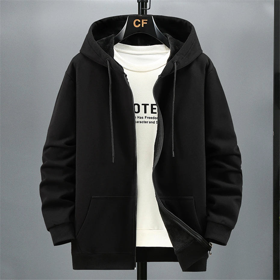 Black hoodie on a hanger with a white shirt underneath against a gray background. OIDWEAR SHADOW_SYSTEM_07 ☰ full-zip hoodie shown worn in a concrete alleyway in winter, highlighting the oversized fit and fleece material.