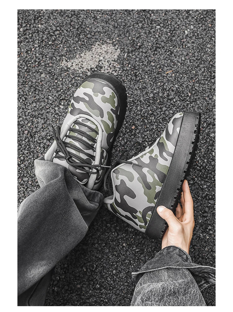 Camouflage-patterned shoes being held on a textured surface. VOIDWEAR CODE_SYSTEM_07 ⚔️ chunky sneaker-style boots shown on a city street in winter, highlighting the microfiber leather upper and thick platform sole.