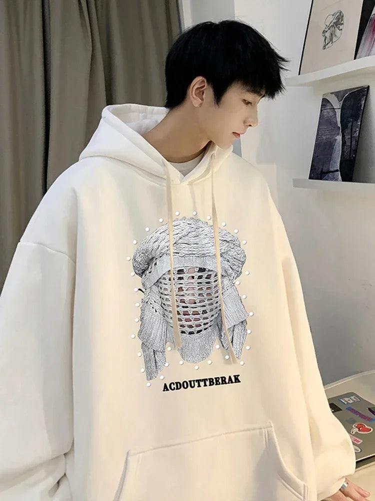 VOIDWEAR VDR_SHDW_07 oversized goth hoodie with masked figure graphic, in black, styled in urban streetwear fit, Person wearing a light-colored hoodie with a graphic design and text in an indoor setting.