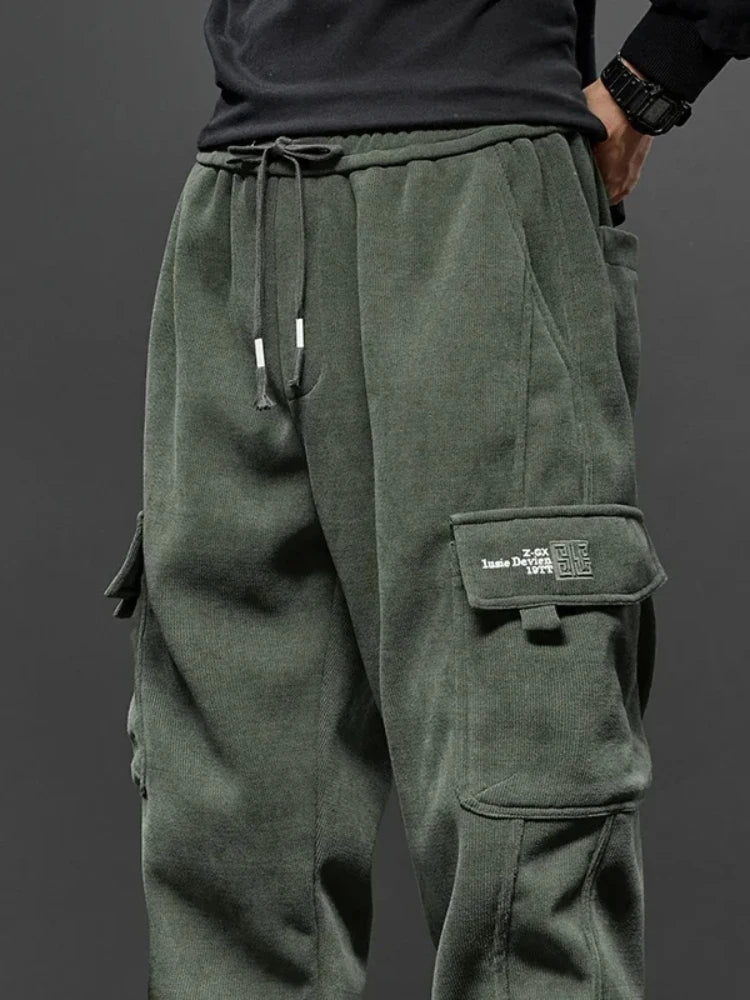 Technical flat lay of Voidwear Flux cargo pants showing pocket configuration and articulated fit