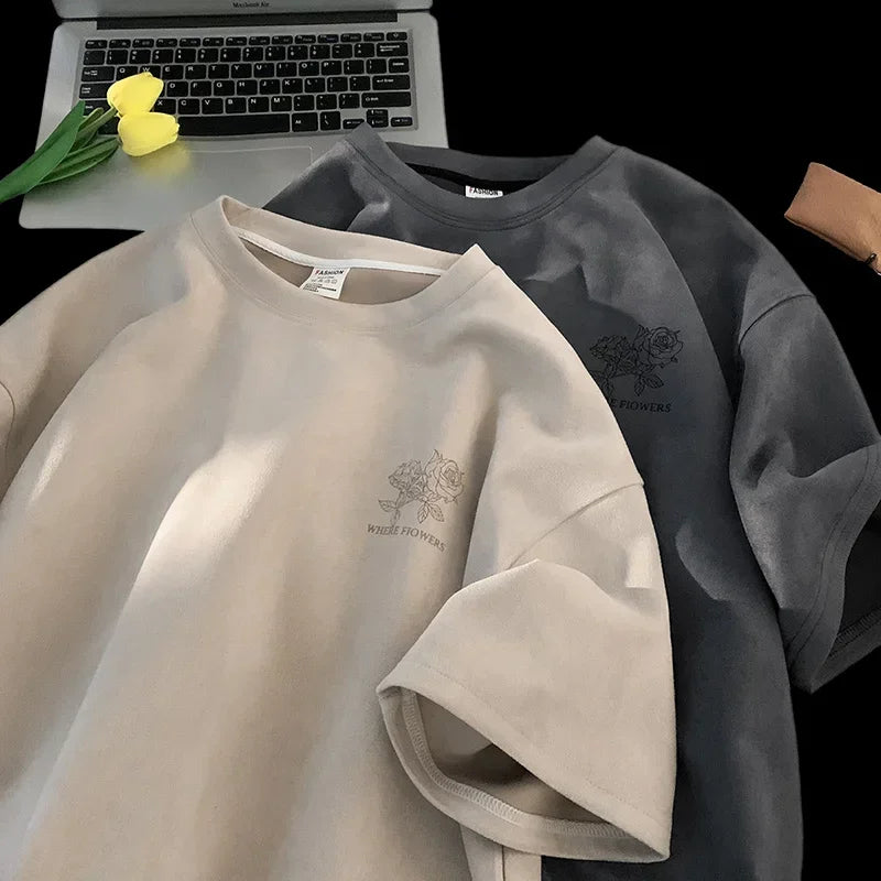 VOIDWEAR VDR_FLO_09 oversized goth floral graphic t-shirt in apricot, styled for streetwear layeringTwo shirts, one beige and one gray, with a brand logo on a black background.
