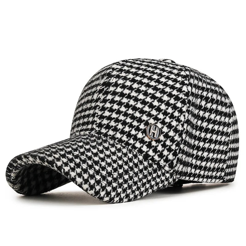 VOIDWEAR SIGNAL_SHADOW_07//◐ houndstooth plaid baseball cap with diamond label insignia and adjustable strap, styled in urban U.S. winter setting.. Black and white checkered cap with a logo on a white background
