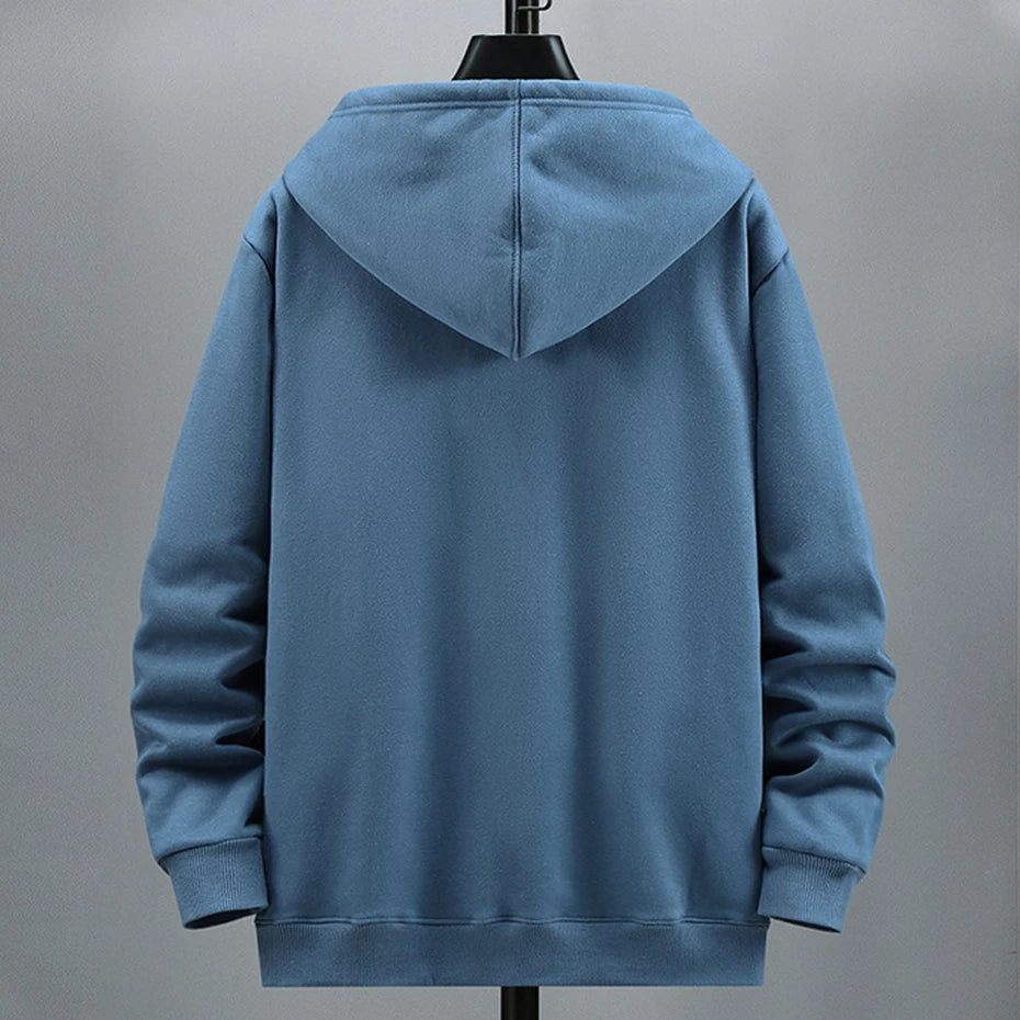 Blue hoodie on a mannequin against a gray background. OIDWEAR SHADOW_SYSTEM_07 ☰ full-zip hoodie shown worn in a concrete alleyway in winter, highlighting the oversized fit and fleece material.