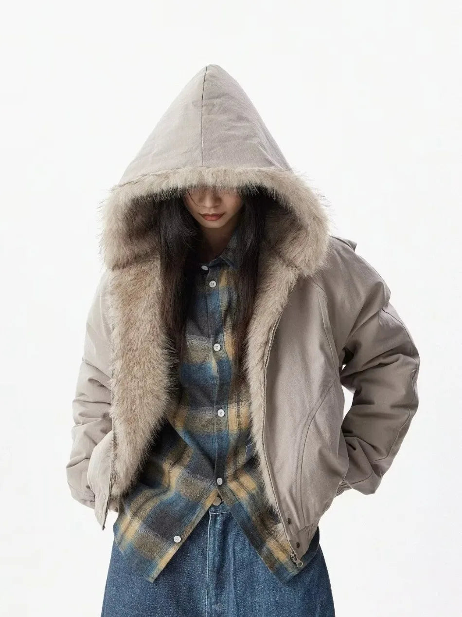 VOIDWEAR™ VDR_25 — a unisex oversized plush hooded jacket. Person wearing a beige hooded jacket with fur lining on a white background