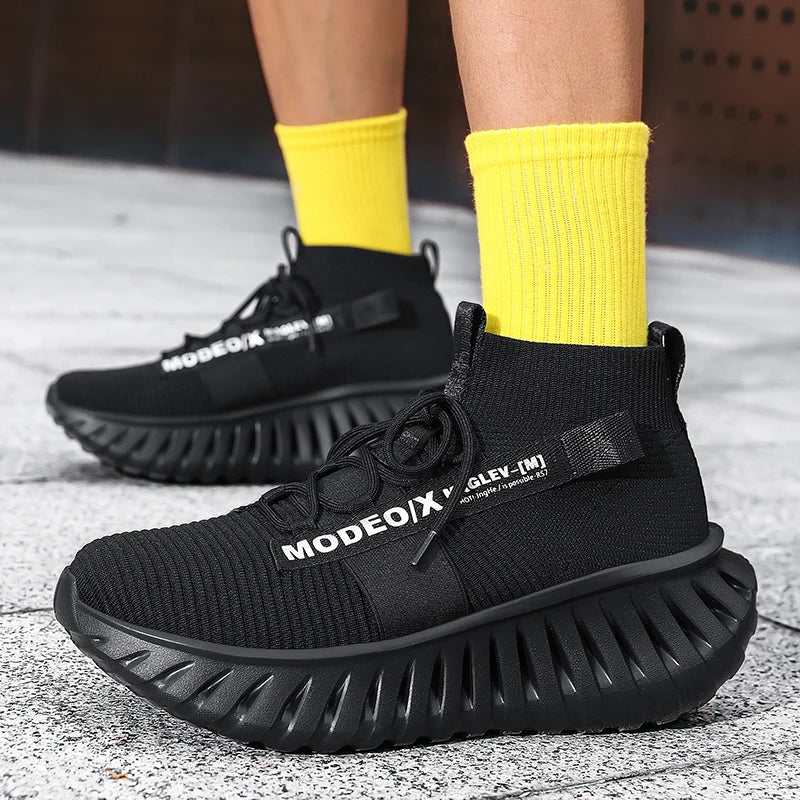 VOIDWEAR SIGNAL_VANISH_07 mesh sneakers, lightweight breathable techwear-inspired streetwear shoes with ankle wrap design. Black sneakers with 'MODEO X' branding worn with yellow socks on a concrete floor.