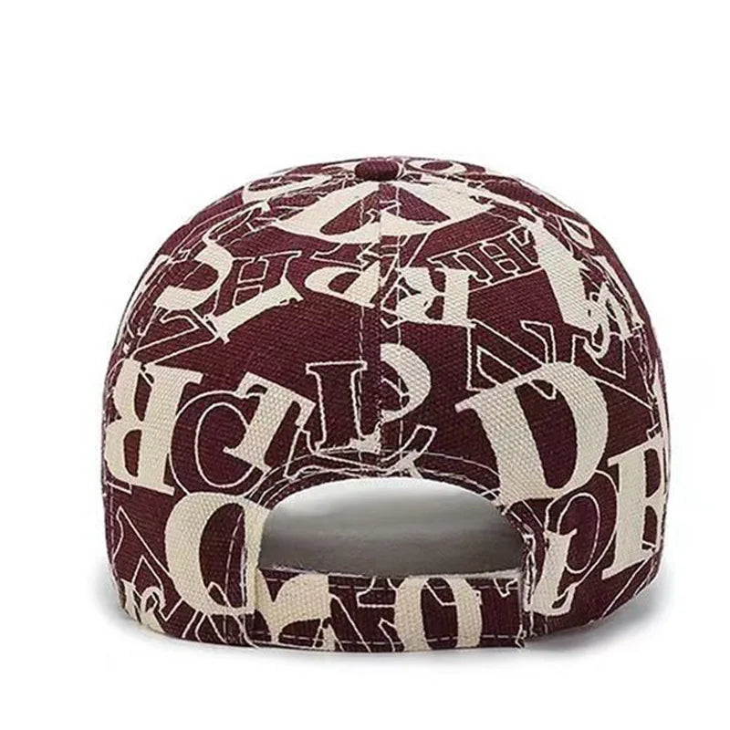 Maroon and beige cap with letter pattern on a white background