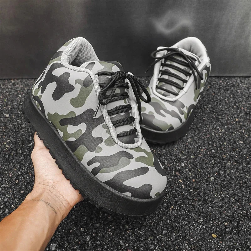 Camouflage sneakers held by a hand on a dark surface. VOIDWEAR CODE_SYSTEM_07 ⚔️ chunky sneaker-style boots shown on a city street in winter, highlighting the microfiber leather upper and thick platform sole.