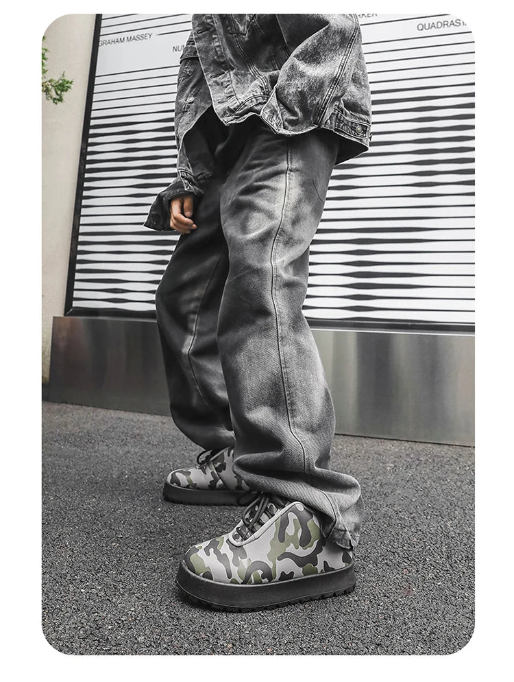 Person wearing camouflage shoes and gray jeans standing in front of a striped wall.VOIDWEAR CODE_SYSTEM_07 ⚔️ chunky sneaker-style boots shown on a city street in winter, highlighting the microfiber leather upper and thick platform sole.