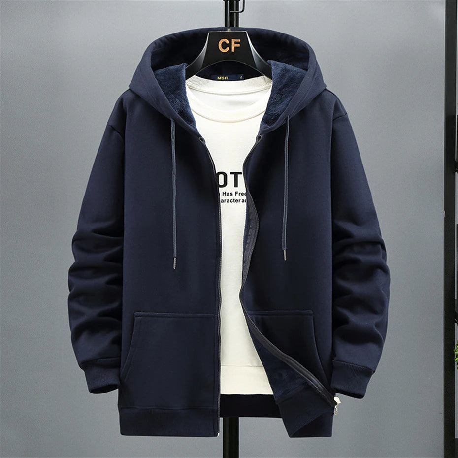 Navy blue hoodie on a gray background. OIDWEAR SHADOW_SYSTEM_07 ☰ full-zip hoodie shown worn in a concrete alleyway in winter, highlighting the oversized fit and fleece material.