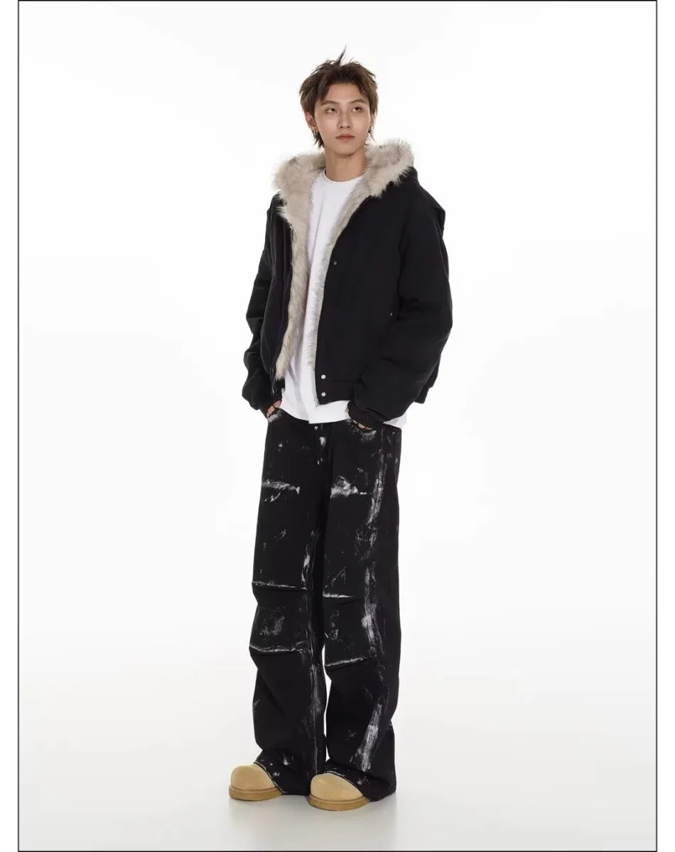 VOIDWEAR™ VDR_25 — a unisex oversized plush hooded jacket. Person wearing a black coat with fur hood and black pants on a white background